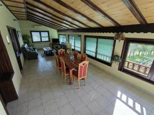 a living room with a wooden ceiling and a table and chairs at Guesthouse Pavličić in Drežnik Grad