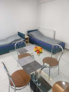 a room with a table and chairs and a bed at Agroturystyka Gorajec Zagroble in Wólka Czarnystok +12 photos