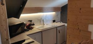 a small kitchen with a sink and a stove at Le nid bucolique in Publier +18 photos