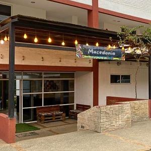 a store front with benches in front of a building at Macedonia in San Clemente +5 photos