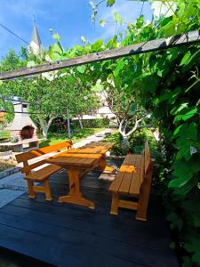 a picnic table and a bench on a deck at Guesthouse Pavličić in Drežnik Grad