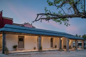 a building with a blue roof at MustBe CFU Studios in Danilia