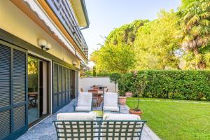 a patio with two chairs and a table on a yard at Villa San Siro Olympic Stadium in Milan +11 photos