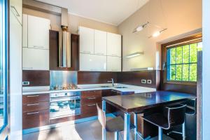 a kitchen with a table and some chairs in it at Villa San Siro Olympic Stadium in Milan