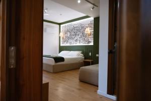 a bedroom with a bed and a large painting on the wall at Tomas Inn in Pogradec