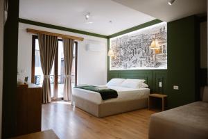 a bedroom with a bed and a painting on the wall at Tomas Inn in Pogradec