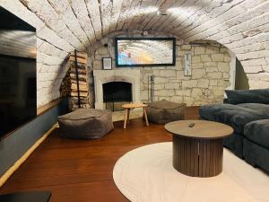 a living room with a couch and a fireplace at Hotel NOSPA in Kuressaare
