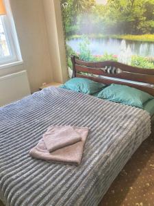 a bed with two towels sitting on top of it at AURa in Zhytomyr