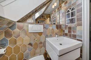 a bathroom with a sink and a toilet at Liiger-Hoern-DG-Wohnung-4-Moewe in Tinnum +12 photos