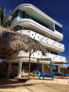 a large white building with a playground in front of it at Condominio Agave del Mar in Coyuca