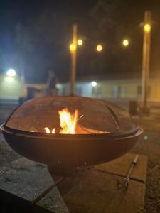 a fire pit in the street at night at Motel Masquerade in Marksville