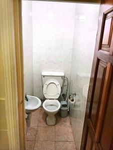 a bathroom with a toilet and a sink at Vesper Apt-Osu in Christiansborg