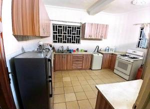 a kitchen with a black refrigerator and a stove at Vesper Apt-Osu in Christiansborg