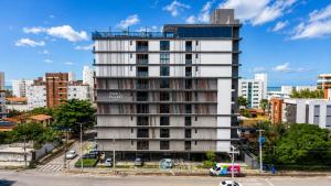a tall white building in the middle of a city at Emunah by 123Quarto in Camalaú