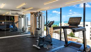 a gym with cardio equipment in a building at Emunah by 123Quarto in Camalaú
