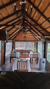 a dining room with tables and chairs in a building at GerSan Oasis in Nigel