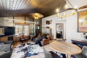 a living room with a wooden ceiling and a table at Rost Place Round-Up in Sturgis