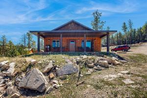 a house on a hill with a pile of rocks at Rost Place Round-Up in Sturgis