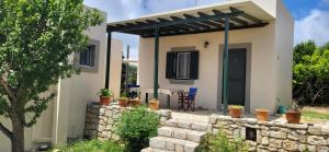 a house with a stone wall in front of it at Ze Di Ma House in Kythira