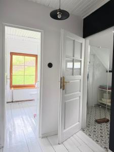 an open white door in a room with a window at Górna79 in Jugowice +31 photos