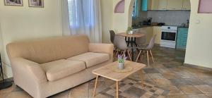 a living room with a couch and a table at Ze Di Ma House in Kythira