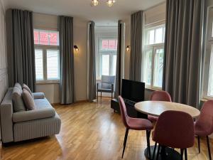 a living room with a couch and a table and chairs at Jon`s Apartments in Pärnu
