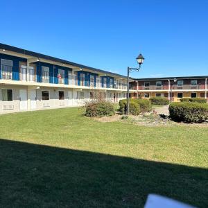 a large apartment building with a lawn in front of it at Americas Best Value Inn in Danville +9 photos