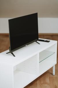 a flat screen tv sitting on a white entertainment center at Aura Residence in San Biagio
