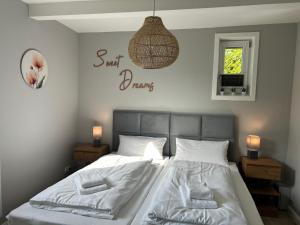 a bedroom with a bed and a sign that says just drank at Ferienhaus Westend in Munster