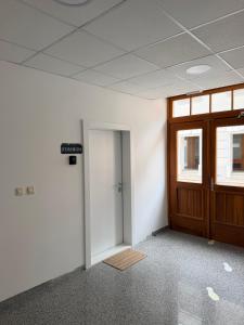 an empty office room with a door and a doorway at Street Apartment Rombon in Bovec