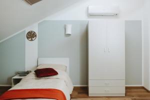 a bedroom with a bed with a red blanket at Aura Residence in San Biagio