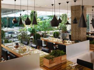 a restaurant with tables and chairs and pendant lights at Sanderson London in London
