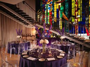 a group of tables in a room with a stained glass window at Sanderson London in London