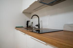 a kitchen with a sink and a wooden counter at Hotel - Restaurant Valley Rose in Vienna