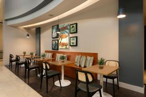 a dining room with wooden tables and chairs at Hyatt Place Manati in Manati +104 photos