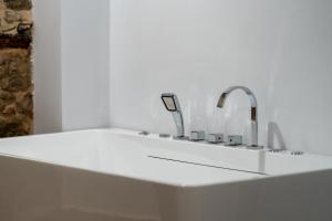a bath tub with a sink and a faucet at Kitarat Berat Castle in Berat +60 photos