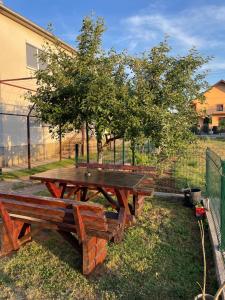 a picnic table in the grass next to a fence at DAS Apartmani Bileća in Bileća