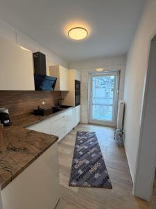 a large kitchen with a counter and a large window at Downtown in Bonn