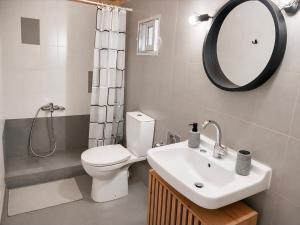 a bathroom with a toilet and a sink and a mirror at Pefanis House in Preveza