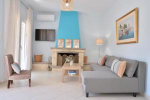 a living room with a couch and a fireplace at Vottas Seaside House Nea Makri in Nea Makri