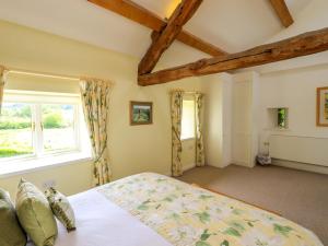 a bedroom with a bed and a window at Kestrel Cottage in Grange Over Sands