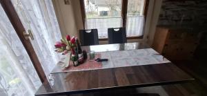 a table with two chairs and a vase of flowers on it at Ferienhaus Roseneck Bad Tabarz in Tabarz