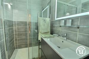 a bathroom with a sink and a shower at Ty amzer'zo in Ploulech +19 photos
