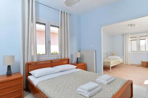 a bedroom with a bed with two white towels on it at Vottas Seaside House Nea Makri in Nea Makri