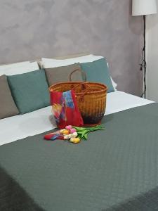 a basket and some flowers on a bed at La Dimora Di Bruna in Naples