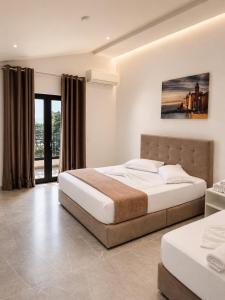 a bedroom with two beds and a large window at Molla Hotel Restorant in Shëngjin +86 photos
