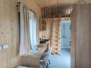 a kitchen with a table and chairs and a sink at Star-Dadaj Lake Camp in Barczewo