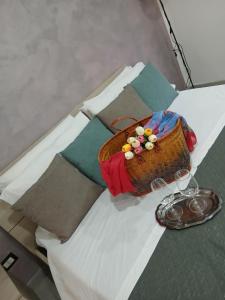 a table with a basket on top of a bed at La Dimora Di Bruna in Naples
