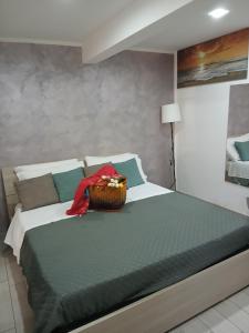 a bedroom with a bed with a basket on it at La Dimora Di Bruna in Naples
