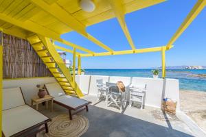 a view of the ocean from the deck of a beach house at Esperanza Fisherman Houses in Mandrakia